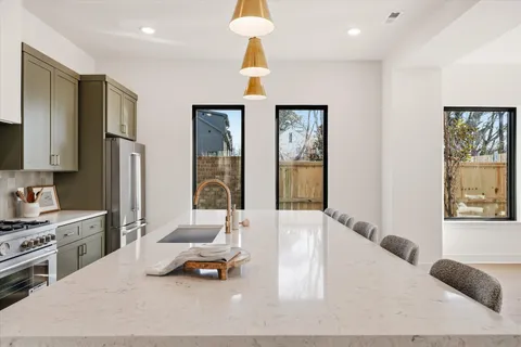 a dining room with furniture a chandelier and wooden floor