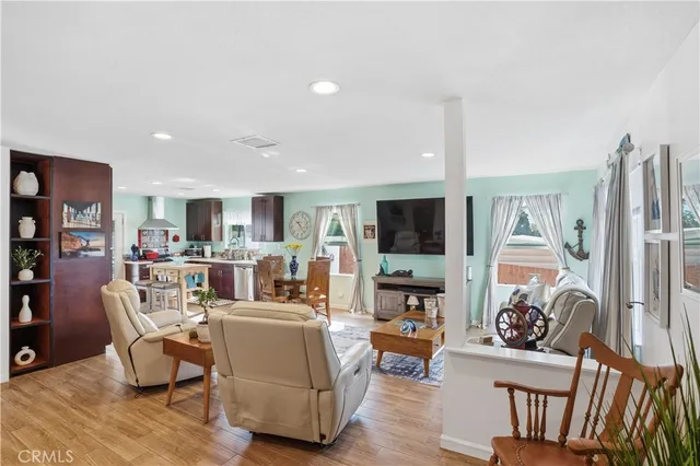a living room with fireplace furniture and a wooden floor