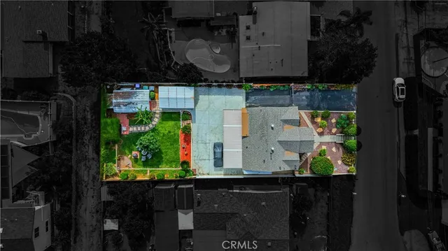 a front view of a house with a yard and a garden