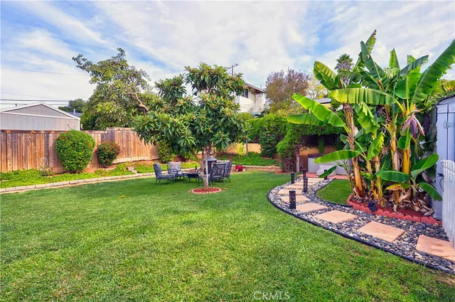 a view of backyard with seating area and green space