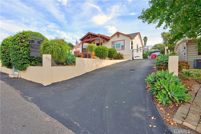 a view of a house with a small yard and floor to ceiling window