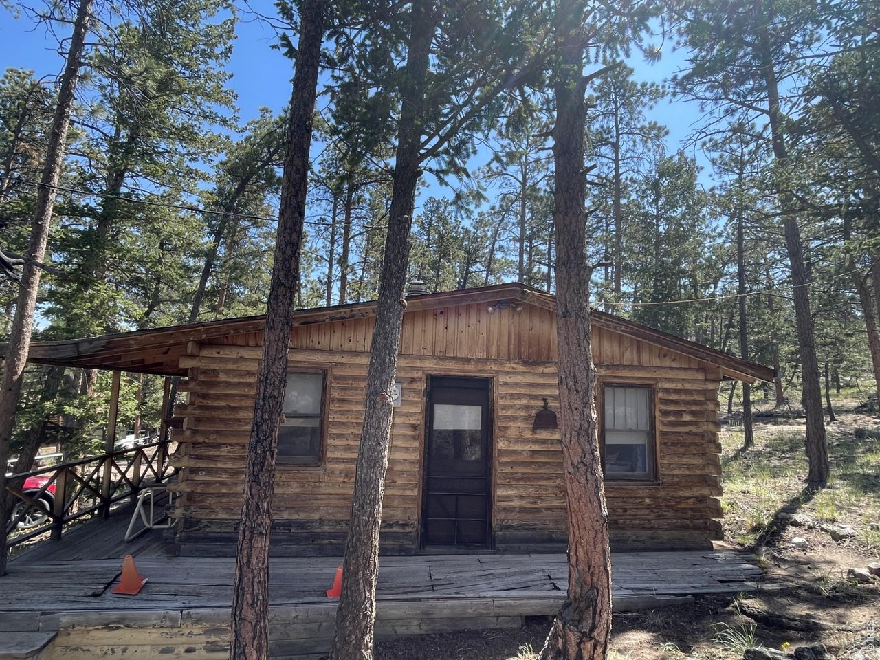 35 Robin Path Red Feather Lakes, CO 80545 - Photo 18 of 25 West elevation showing deck needing repairs.