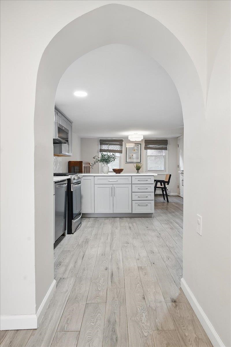 221 Terrace Avenue Jersey City, NJ 07307 - Photo 14 of 37 a large white kitchen with a stove top oven and kitchen island