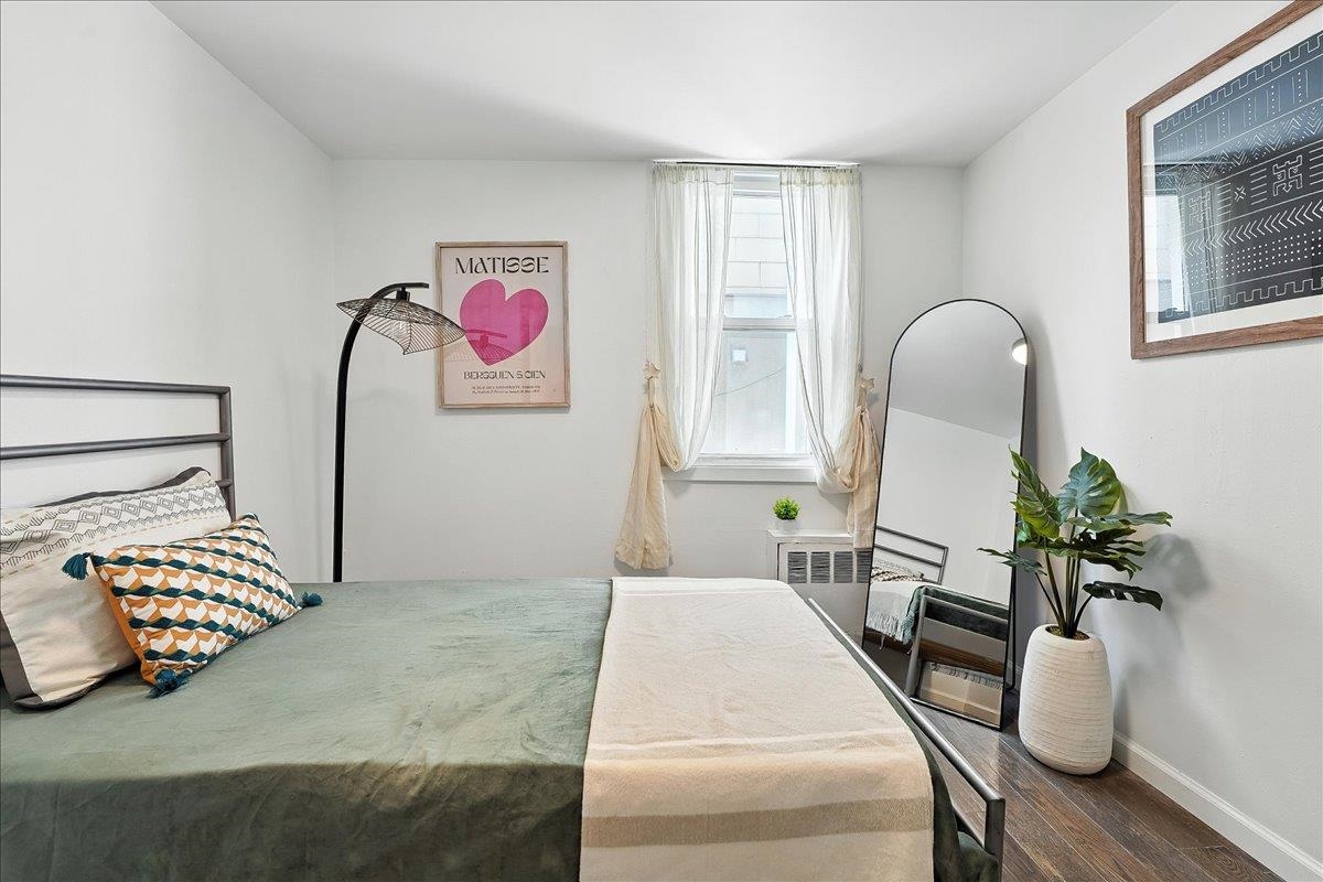 221 Terrace Avenue Jersey City, NJ 07307 - Photo 24 of 37 a bedroom with furniture and a potted plant