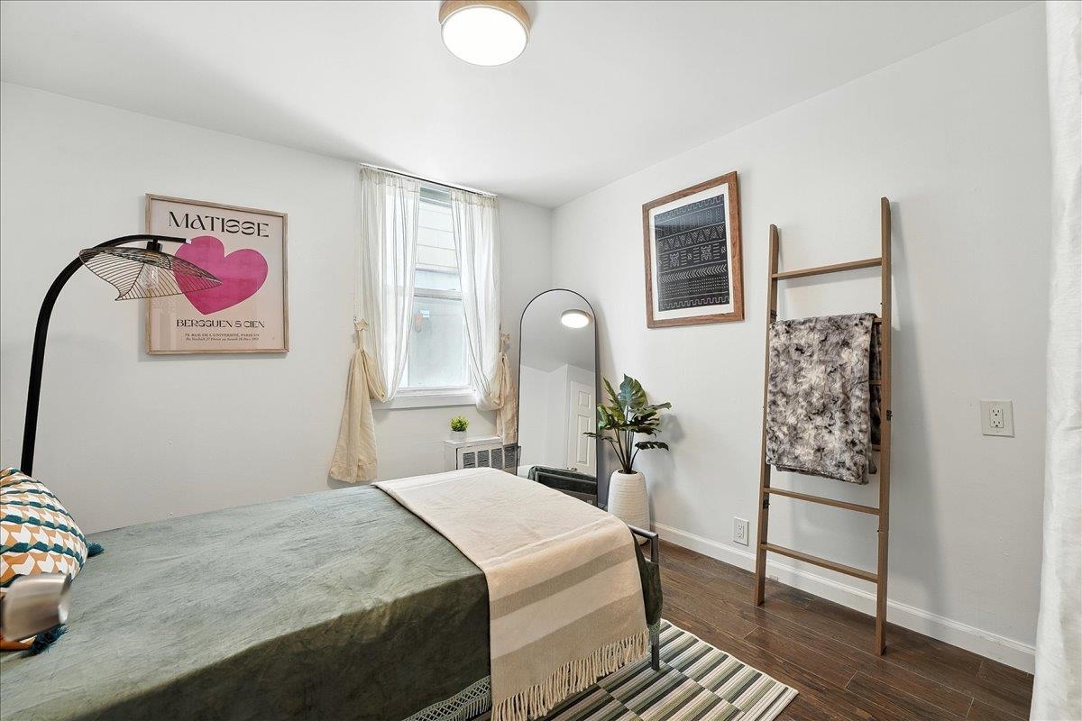 221 Terrace Avenue Jersey City, NJ 07307 - Photo 25 of 37 a bedroom with a bed and a chandelier