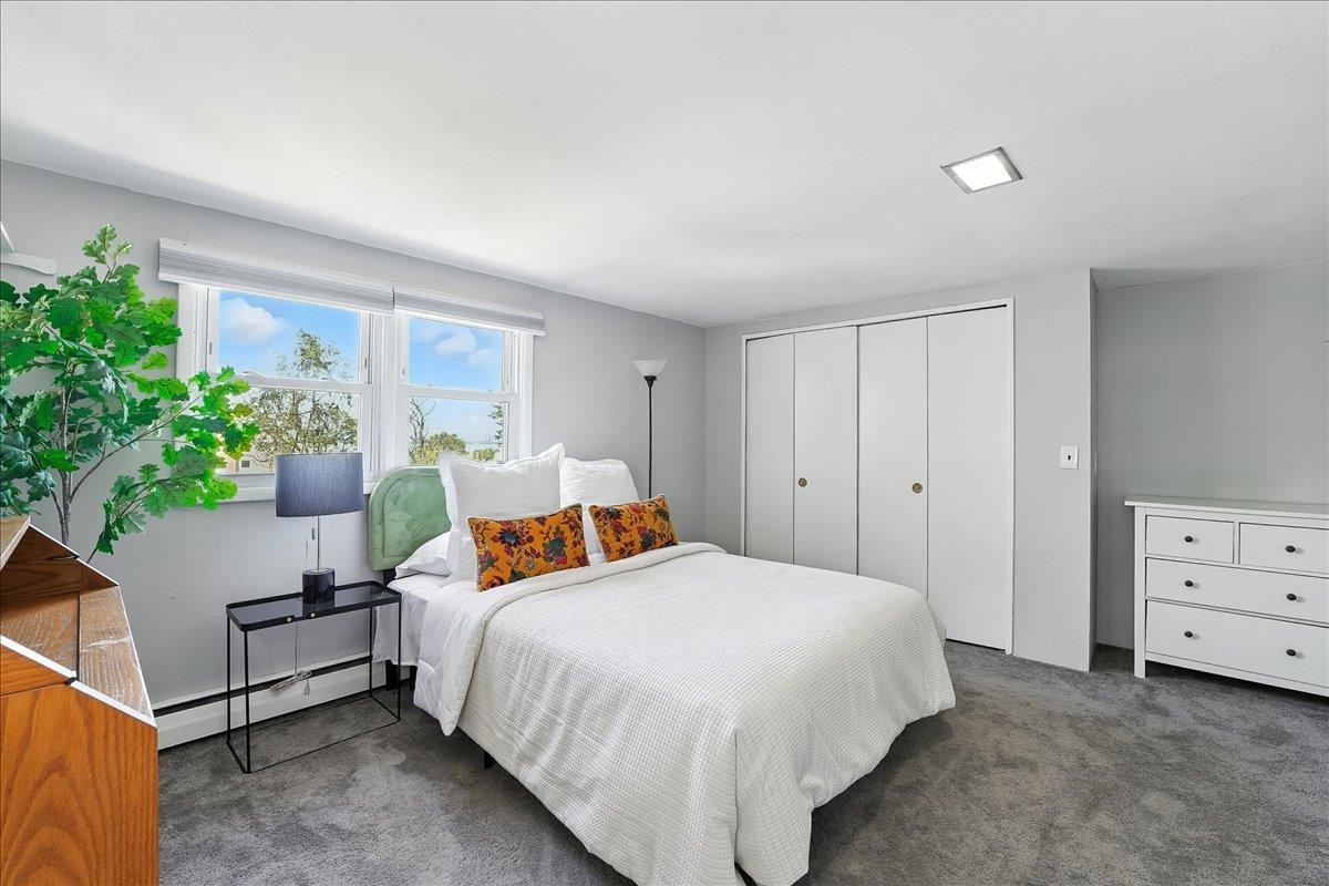 221 Terrace Avenue Jersey City, NJ 07307 - Photo 27 of 37 a bedroom with a bed and a dresser