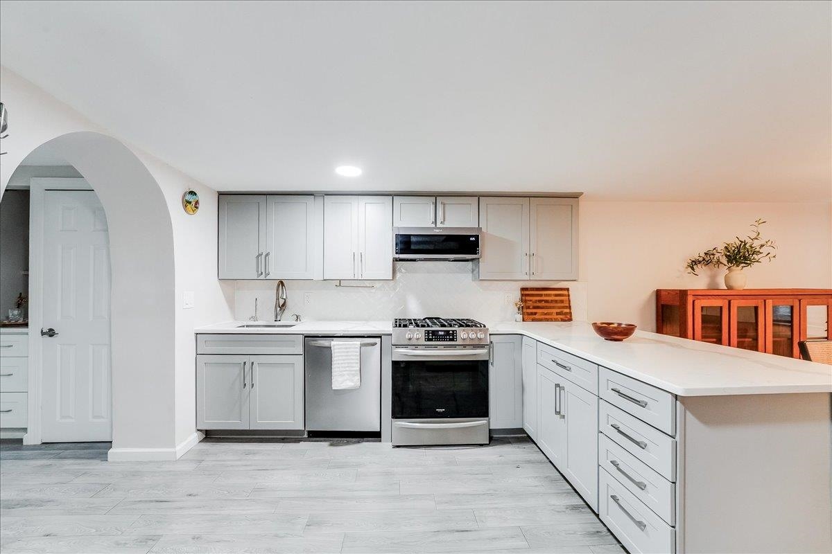 221 Terrace Avenue Jersey City, NJ 07307 - Photo 7 of 37 a kitchen with stainless steel appliances granite countertop a sink and cabinets