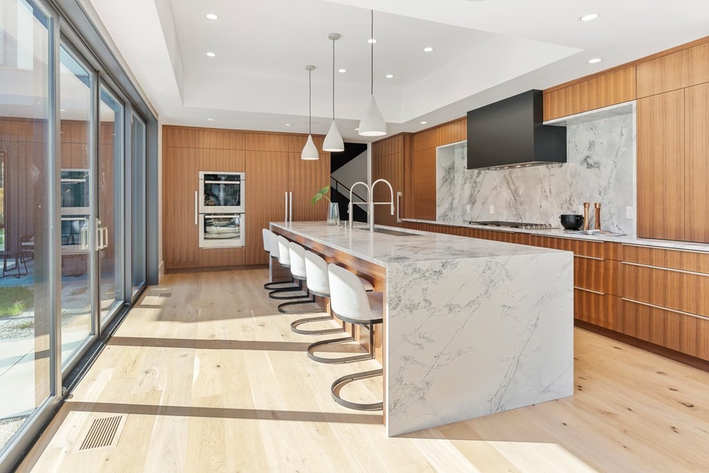 101 Black Oak Road Weston, MA 02493 - Photo 8 of 42 a large kitchen with stainless steel appliances kitchen island granite countertop a refrigerator a sink and a stove