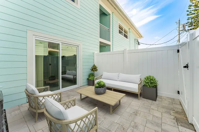 a view of a patio with couches table and chairs