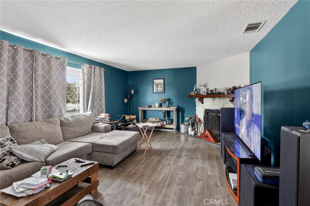 21985 Maumee Road Apple Valley, CA 92308 - Photo 11 of 30 a living room with furniture and a flat screen tv