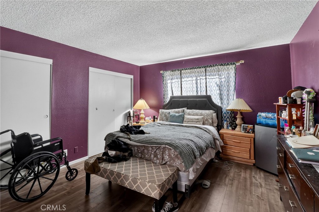 21985 Maumee Road Apple Valley, CA 92308 - Photo 18 of 30 a bedroom with a bed and wooden floor