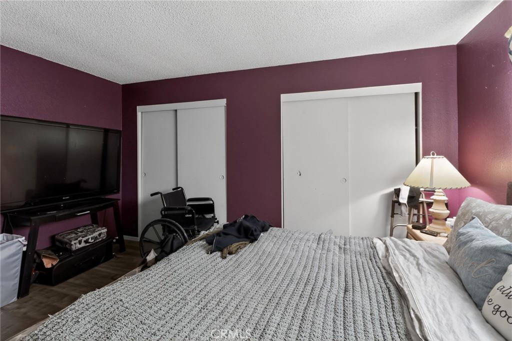 21985 Maumee Road Apple Valley, CA 92308 - Photo 22 of 30 a bedroom with bed and a flat screen tv