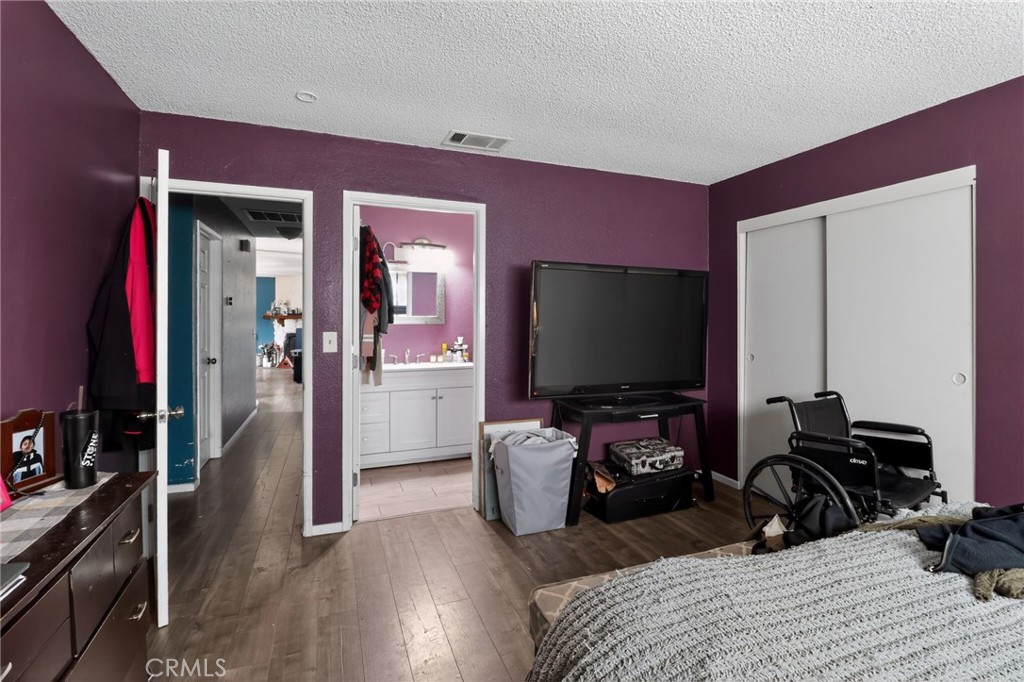 21985 Maumee Road Apple Valley, CA 92308 - Photo 23 of 30 a bedroom with a bed and a flat screen tv