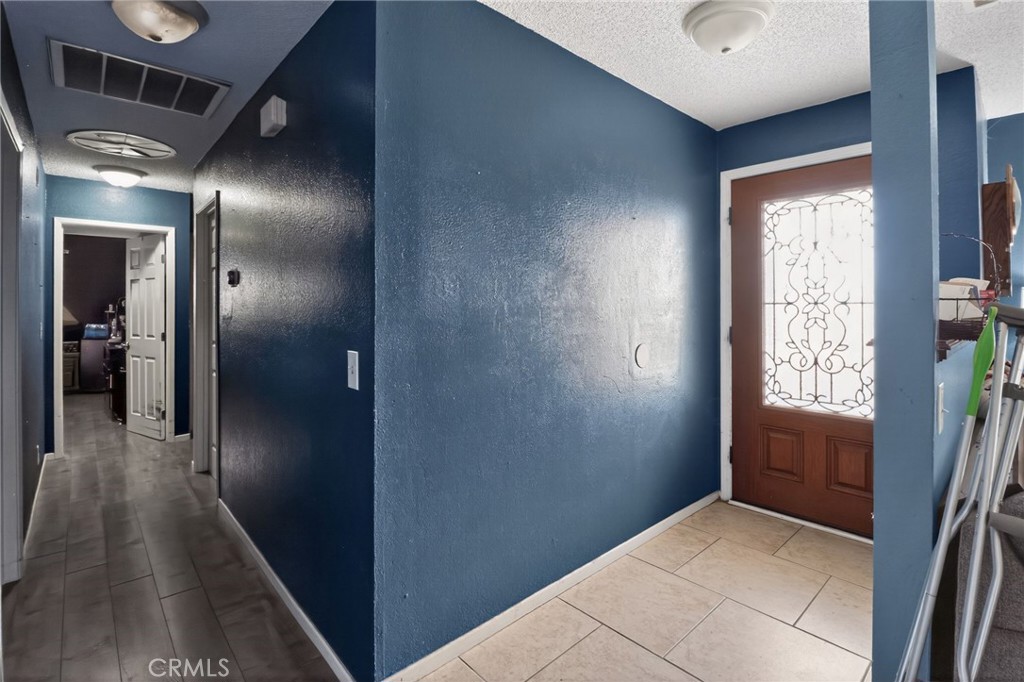 21985 Maumee Road Apple Valley, CA 92308 - Photo 9 of 30 a view of hallway with stairs and wooden floor