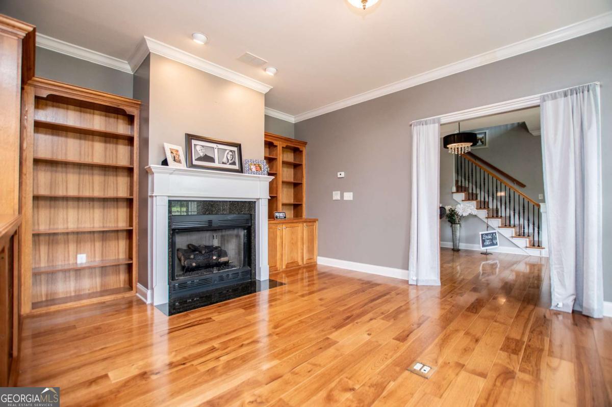 1074 Glenloch Road Roopville, GA 30170 - Photo 11 of 98 a view of a livingroom with wooden floor and a fireplace