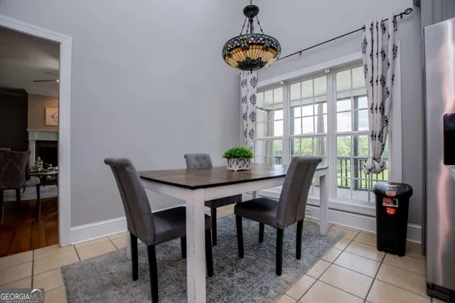 a living room with furniture a chandelier and a flat screen tv