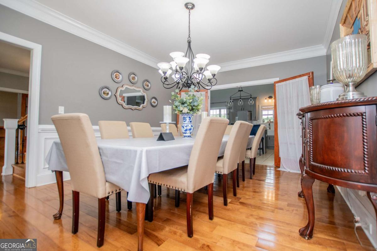 1074 Glenloch Road Roopville, GA 30170 - Photo 23 of 98 a view of a dining room with furniture and wooden floor