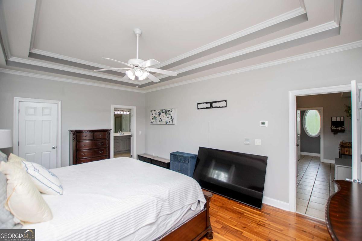 1074 Glenloch Road Roopville, GA 30170 - Photo 26 of 98 a bedroom with a bed and a flat screen tv