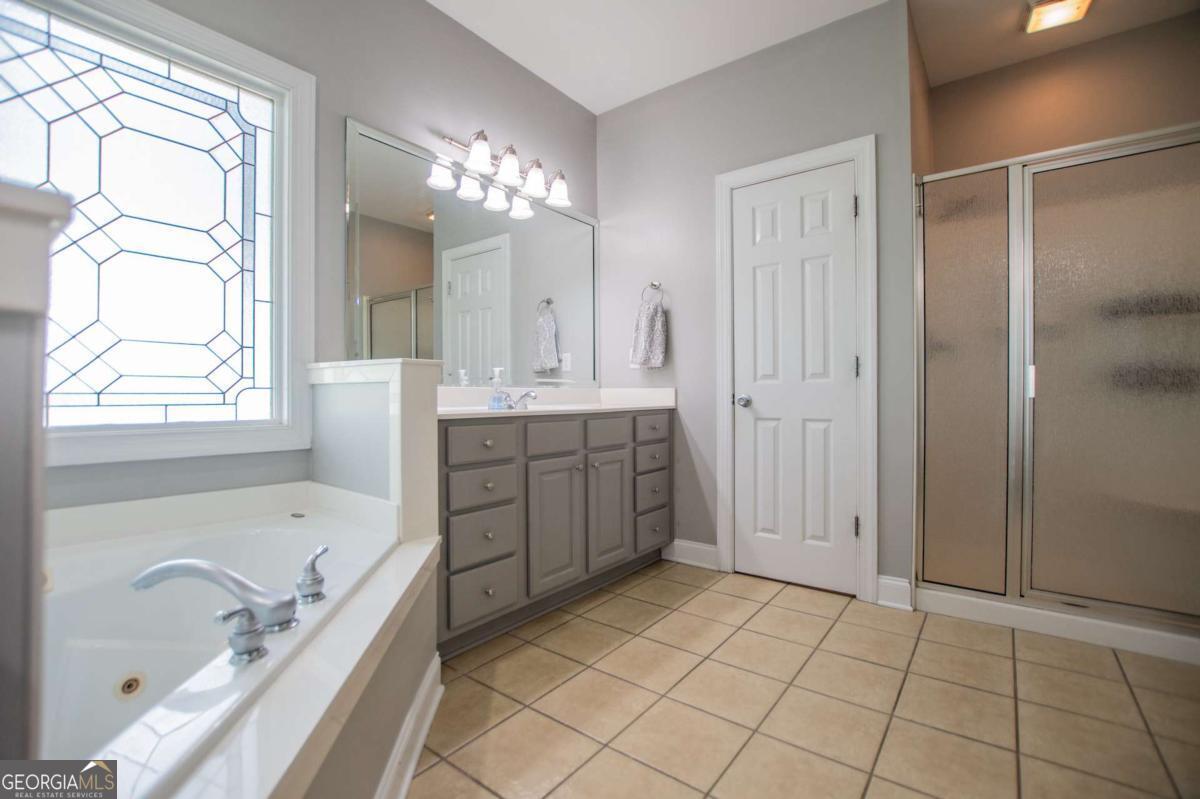 1074 Glenloch Road Roopville, GA 30170 - Photo 28 of 98 a spacious bathroom with a tub sink and mirror