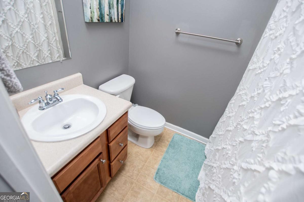 1074 Glenloch Road Roopville, GA 30170 - Photo 40 of 98 a bathroom with a sink a toilet and a mirror