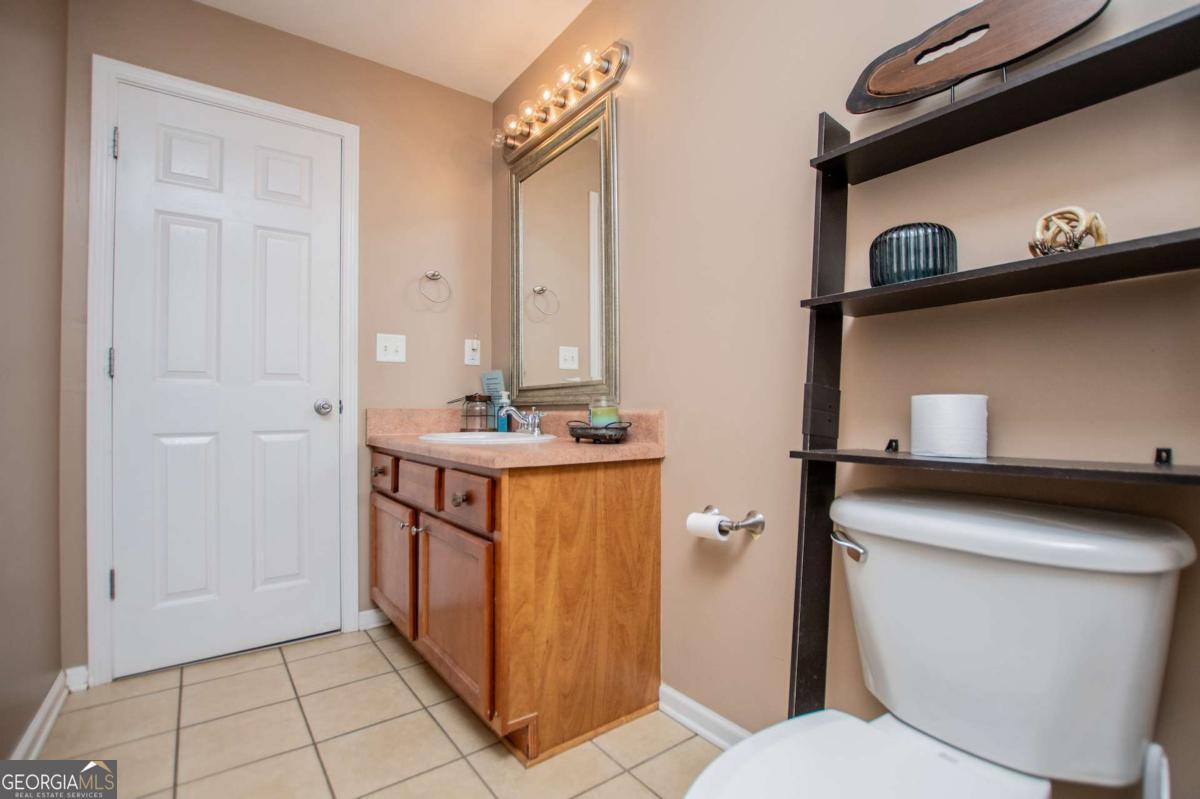 1074 Glenloch Road Roopville, GA 30170 - Photo 41 of 98 a bathroom with a toilet a sink and mirror