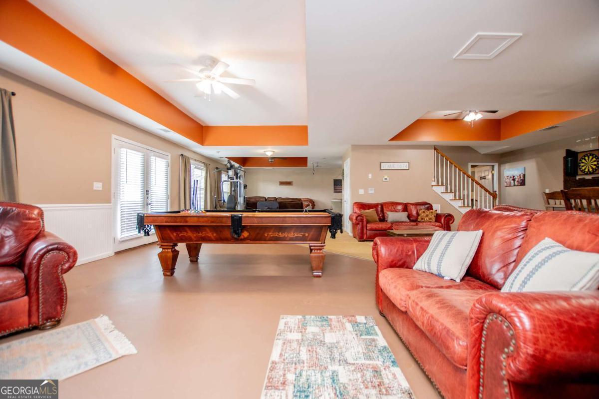 1074 Glenloch Road Roopville, GA 30170 - Photo 42 of 98 a living room with furniture a fireplace and a potted plant