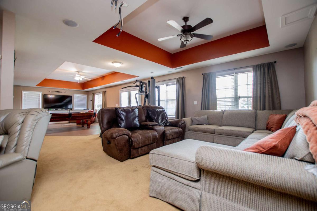 1074 Glenloch Road Roopville, GA 30170 - Photo 44 of 98 a living room with furniture a ceiling fan and a window