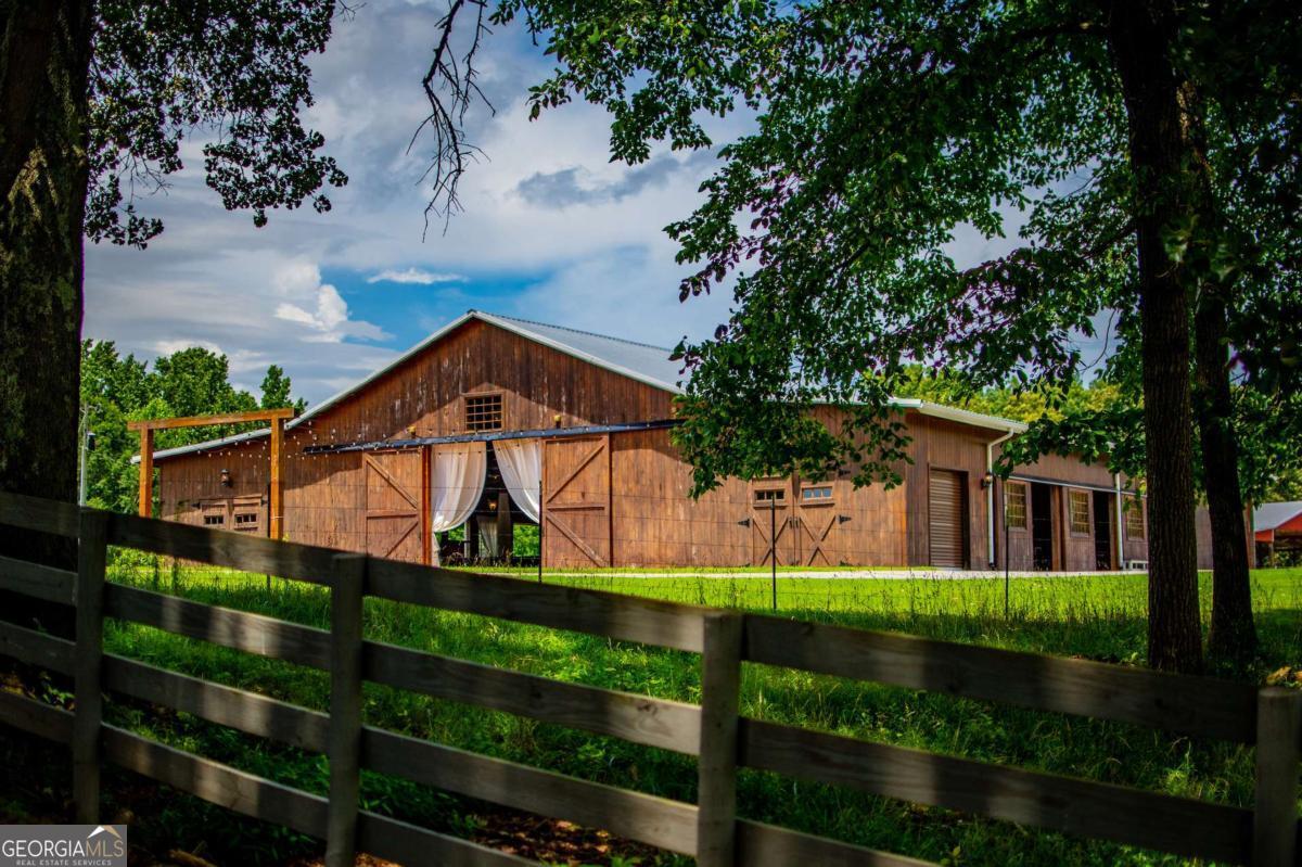 1074 Glenloch Road Roopville, GA 30170 - Photo 54 of 98 a view of a house with a small yard and wooden fence