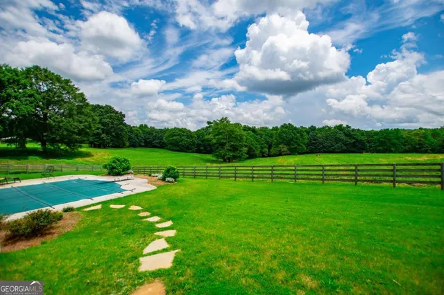 a view of a livingroom with wooden floor and a fireplace