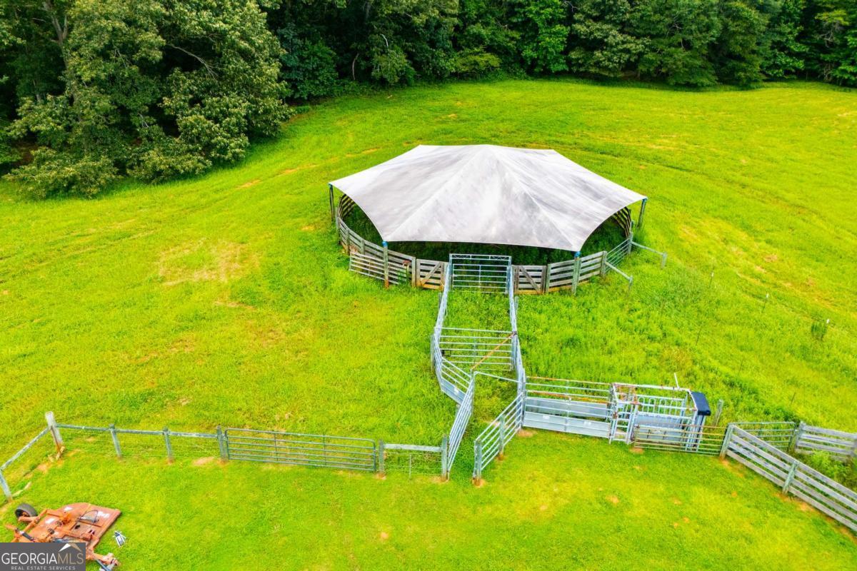 1074 Glenloch Road Roopville, GA 30170 - Photo 76 of 98 a view of a swimming pool with a table and chairs