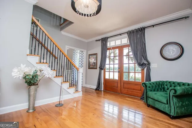a living room with furniture a fireplace and large windows