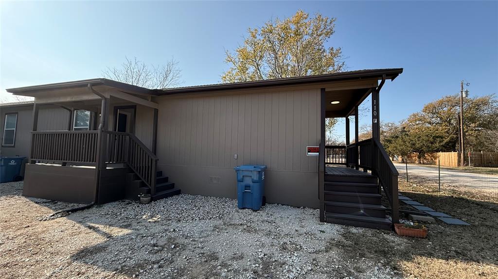 110 Crockett Street, Unit A Valley View, TX 76272 - Photo 15 of 17 a side view of a house with backyard