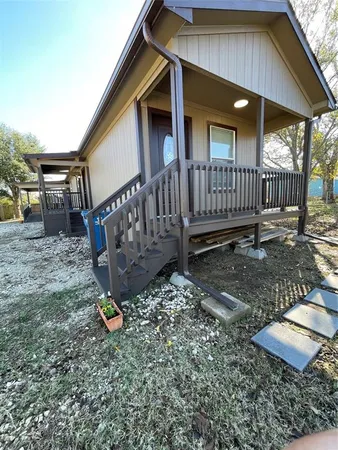 a view of a house with backyard and wooden fence