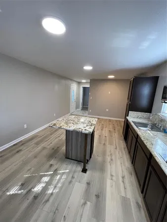 a kitchen with a sink and a stove top oven