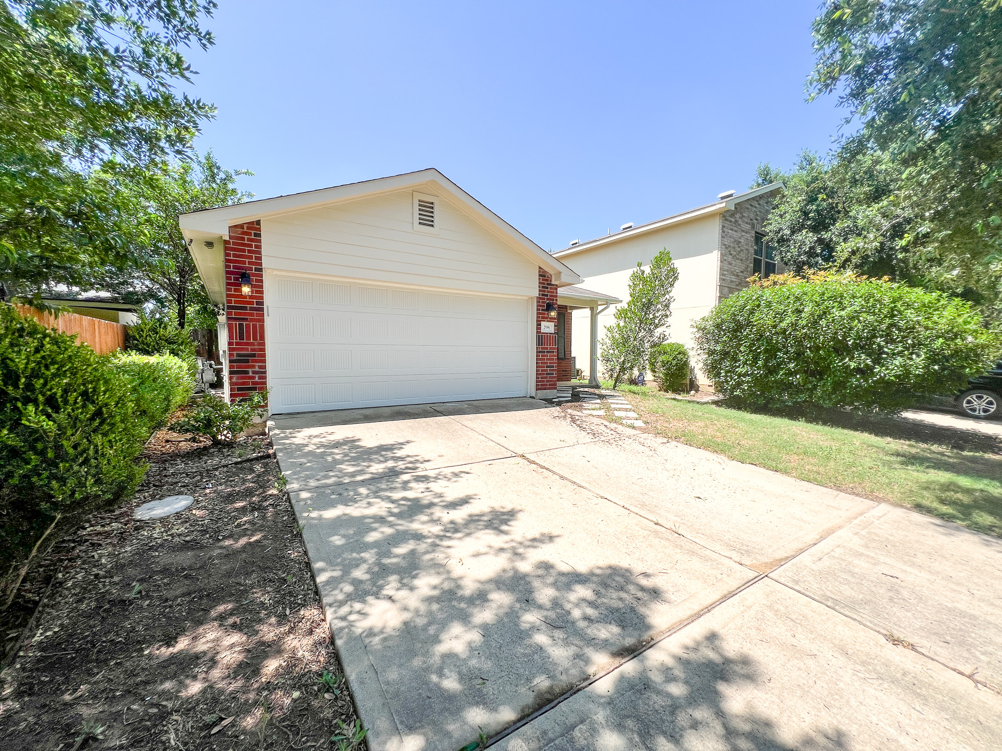 298 Jack Rabbit Lane Buda, TX 78610 - Photo 21 of 24 A classic brick and siding residence, neatly landscaped with a concrete driveway leading to the integrated garage.