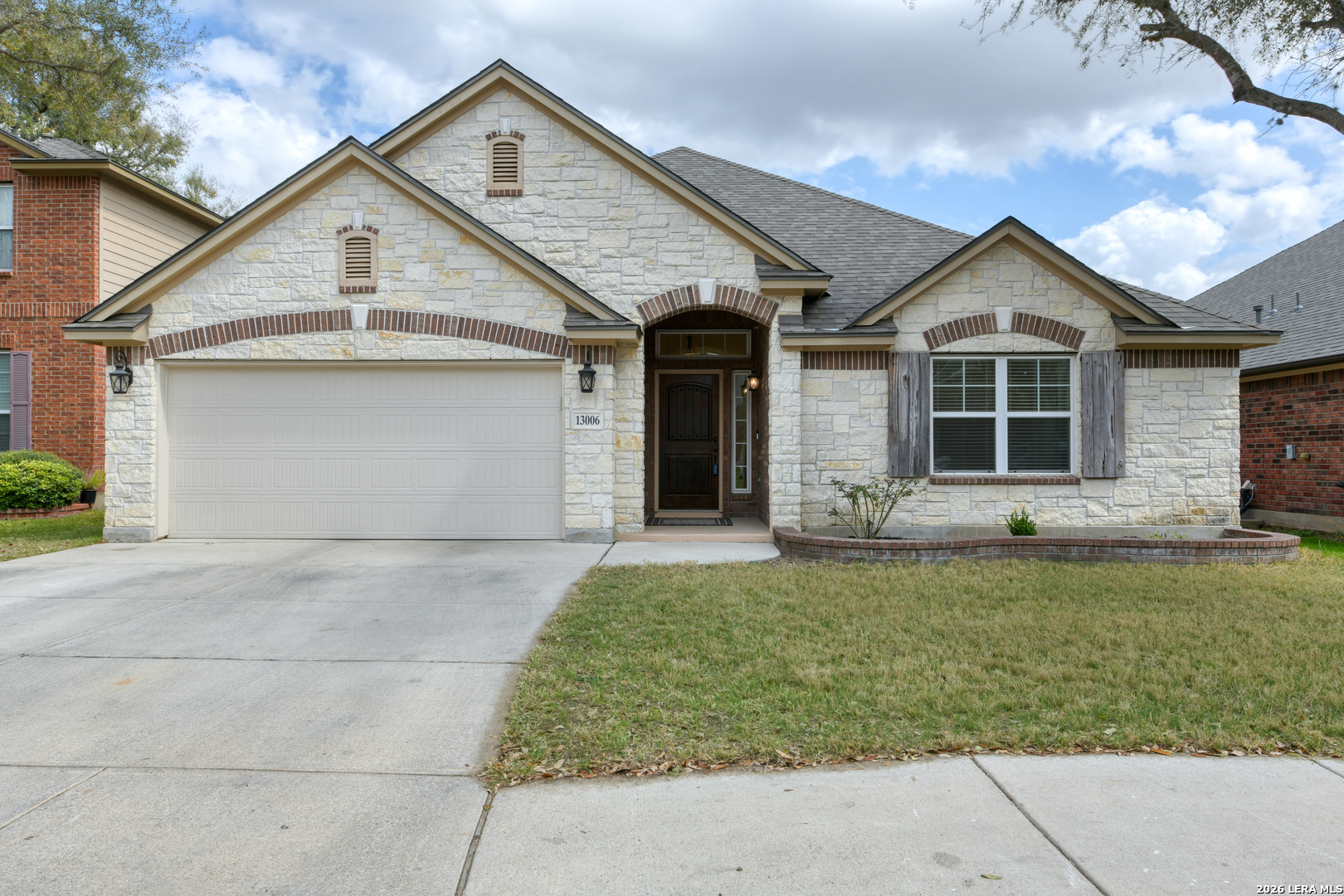 13006 Essen Forest Helotes, TX 78023 - Photo 1 of 1 a front view of a house with a garden and yard