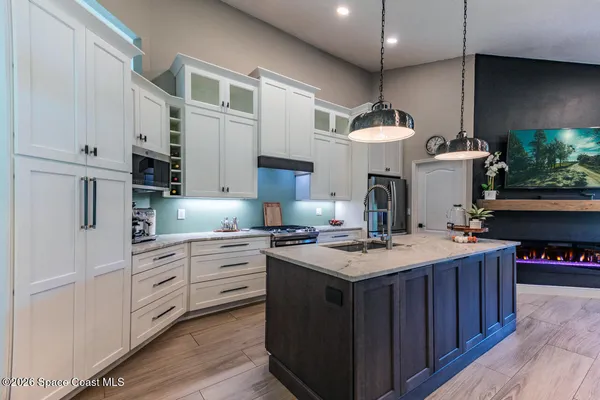 a kitchen with a stove and a refrigerator