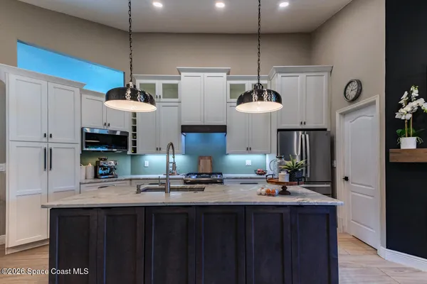 a kitchen with stainless steel appliances a sink and a stove