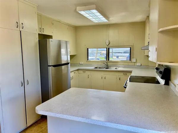 a kitchen with a refrigerator sink and cabinets