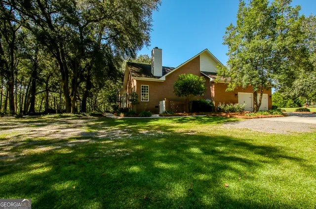 a living room with furniture a chandelier and a fireplace