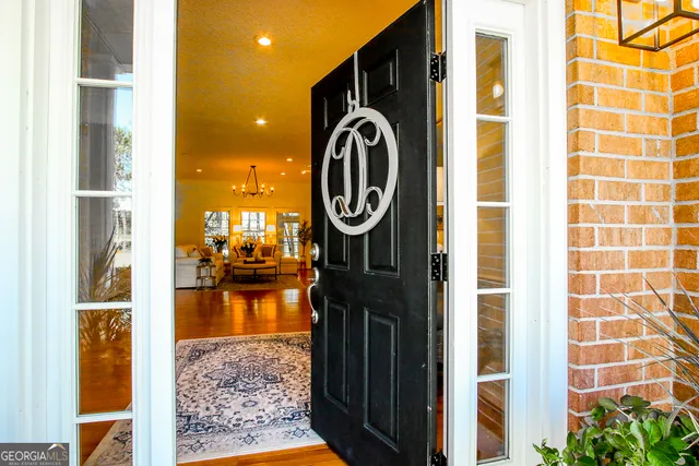 a living room with furniture kitchen view and a large window
