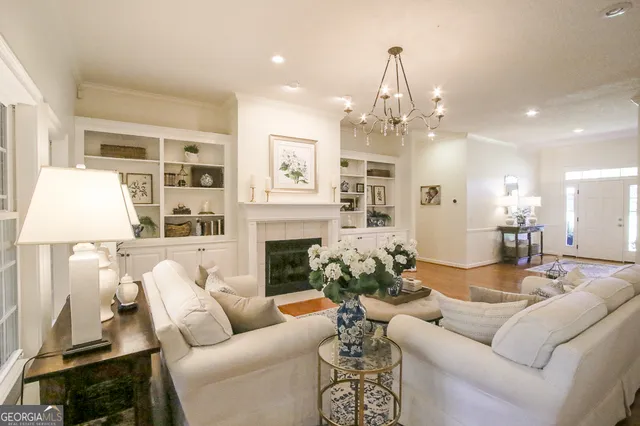 a bedroom with a bed a dresser and potted plant
