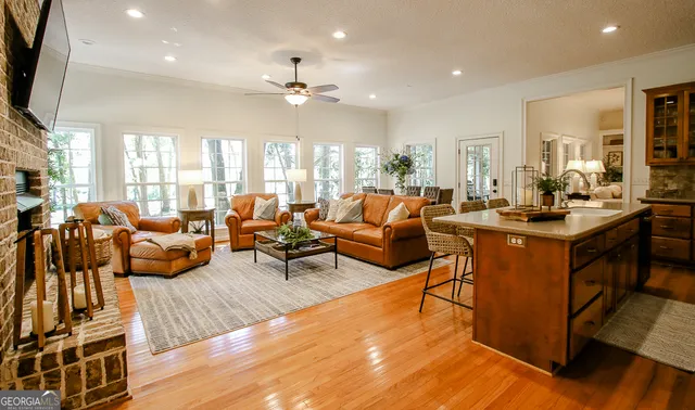 a bed sitting in a bedroom next to a window and a chandelier