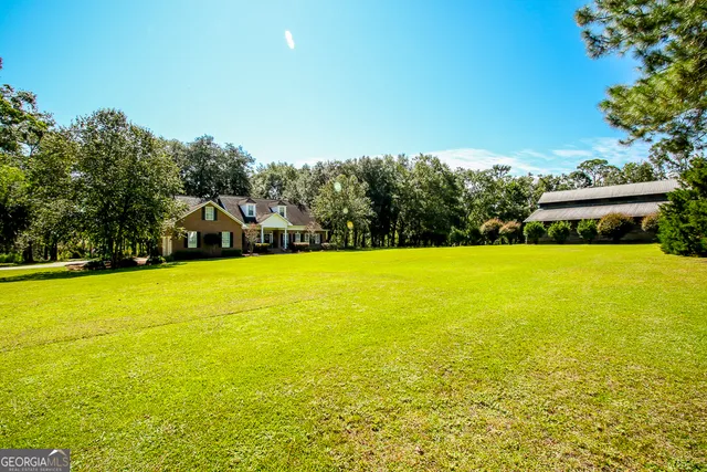 a view of a dining room with furniture a chandelier and wooden floor