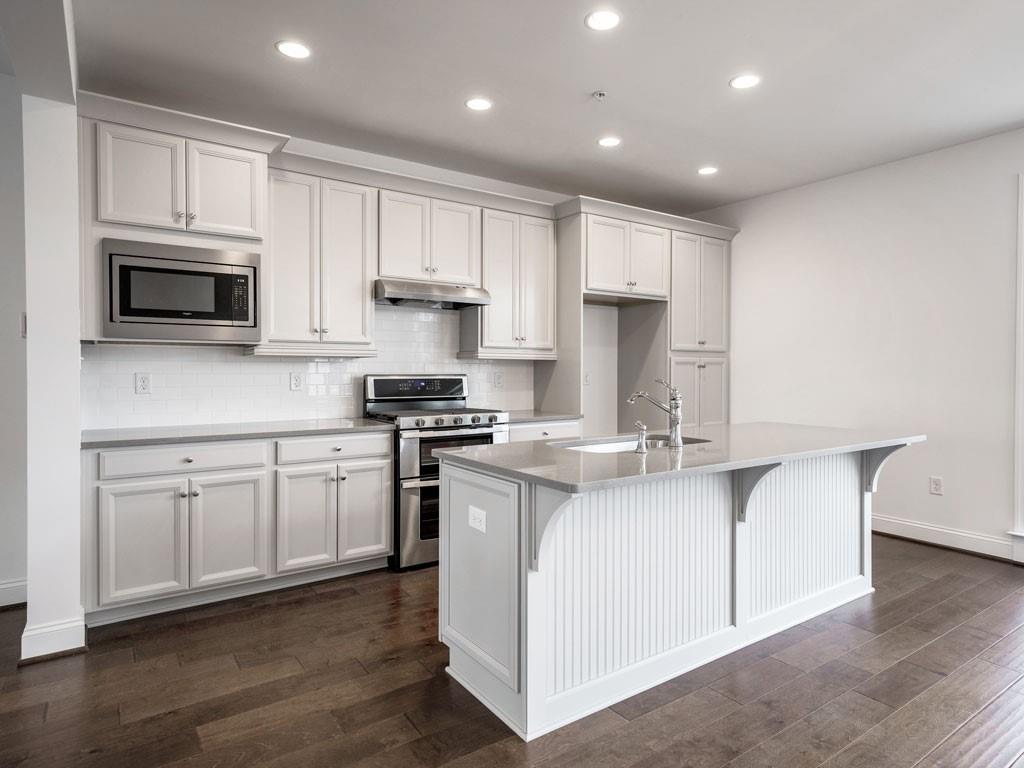122 Gress Road Cranberry Township, PA 16066 - Photo 11 of 25 a kitchen with stainless steel appliances granite countertop a stove a sink and a microwave