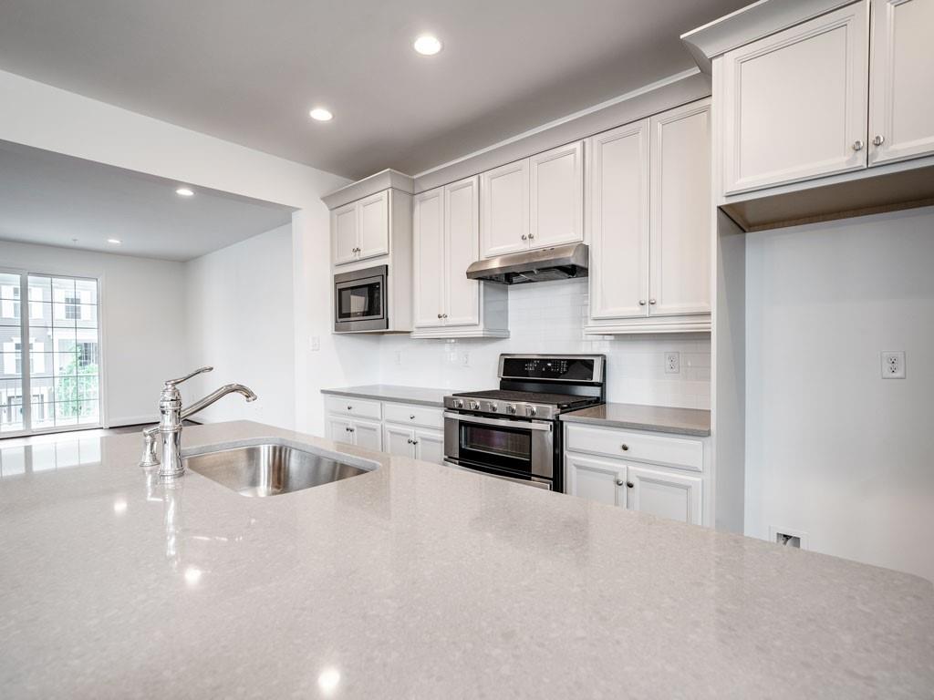 122 Gress Road Cranberry Township, PA 16066 - Photo 12 of 25 a kitchen with granite countertop a stove and a sink