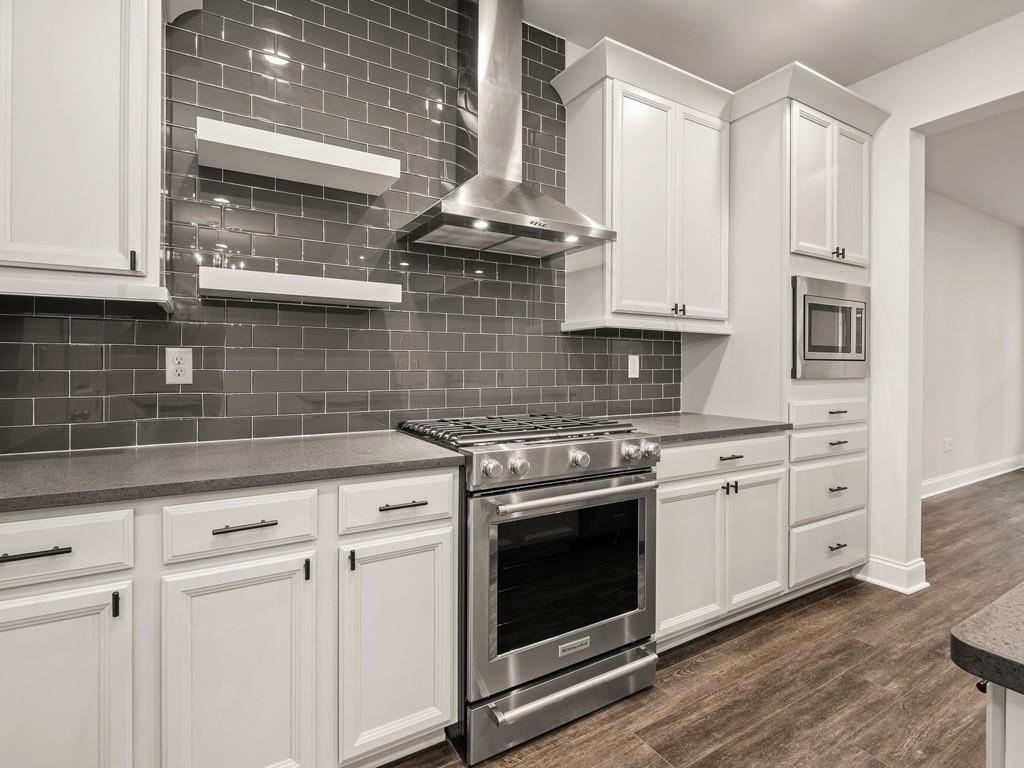 122 Gress Road Cranberry Township, PA 16066 - Photo 5 of 25 a kitchen with stainless steel appliances granite countertop a stove and white cabinets