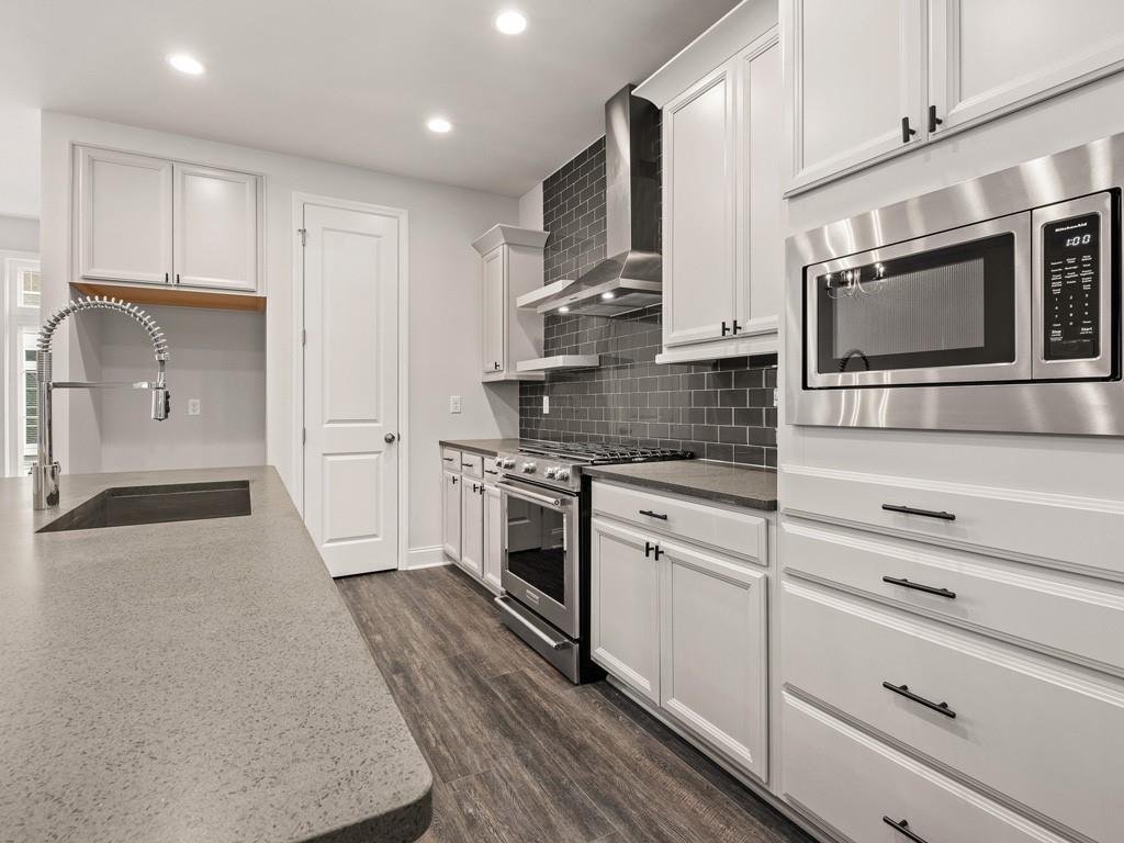 122 Gress Road Cranberry Township, PA 16066 - Photo 6 of 25 a kitchen with stainless steel appliances granite countertop a stove a sink and a microwave