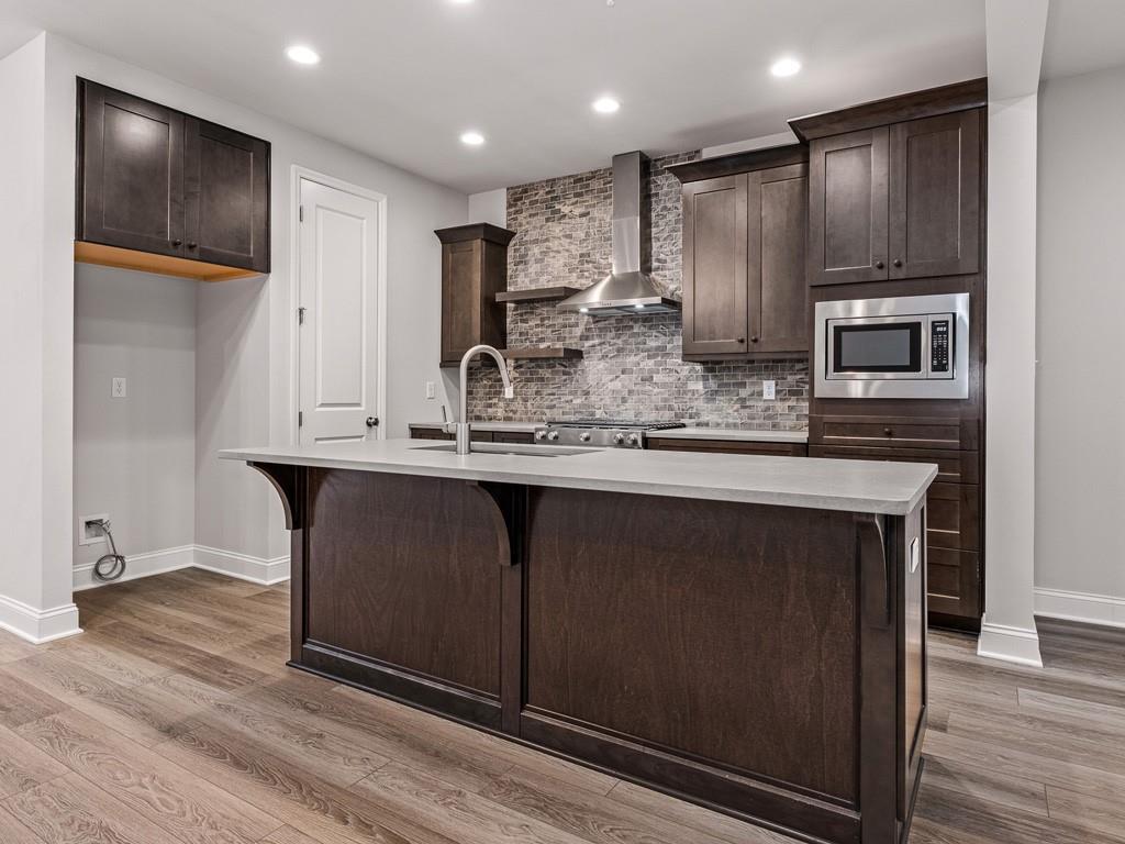 122 Gress Road Cranberry Township, PA 16066 - Photo 7 of 25 a kitchen with kitchen island granite countertop wooden cabinets and refrigerator