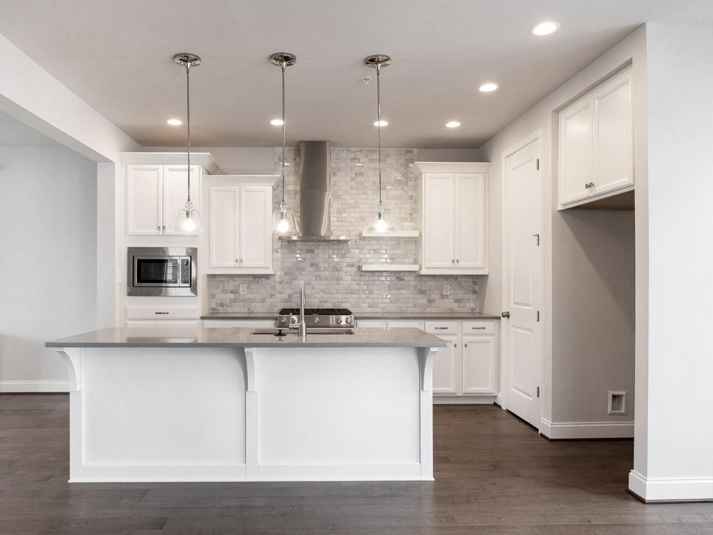 122 Gress Road Cranberry Township, PA 16066 - Photo 9 of 25 a kitchen with stainless steel appliances granite countertop a sink a stove a refrigerator and island with wooden floor